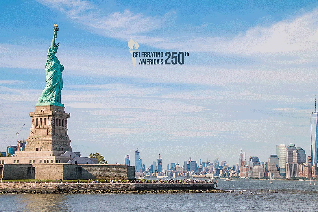 Statue of Liberty on Liberty Island with the New York City skyline across the harbor, overlaid with 'Celebrating America's 250th' text